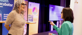 Two women smiling talking to each other at one of Aalto Startup Center's event