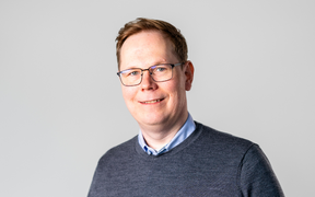 Portrait of Kimmo Järvinen, from the Xiphera team. A man smiling at the camera
